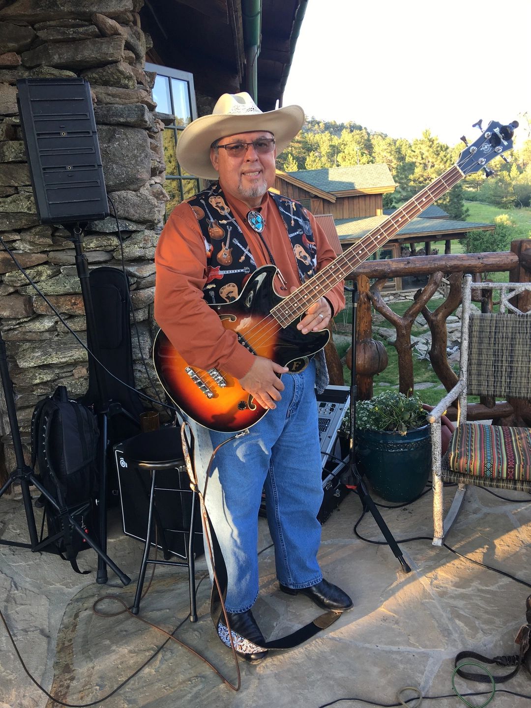 Frank Sanchez playing bass outdoors at a mountain venue