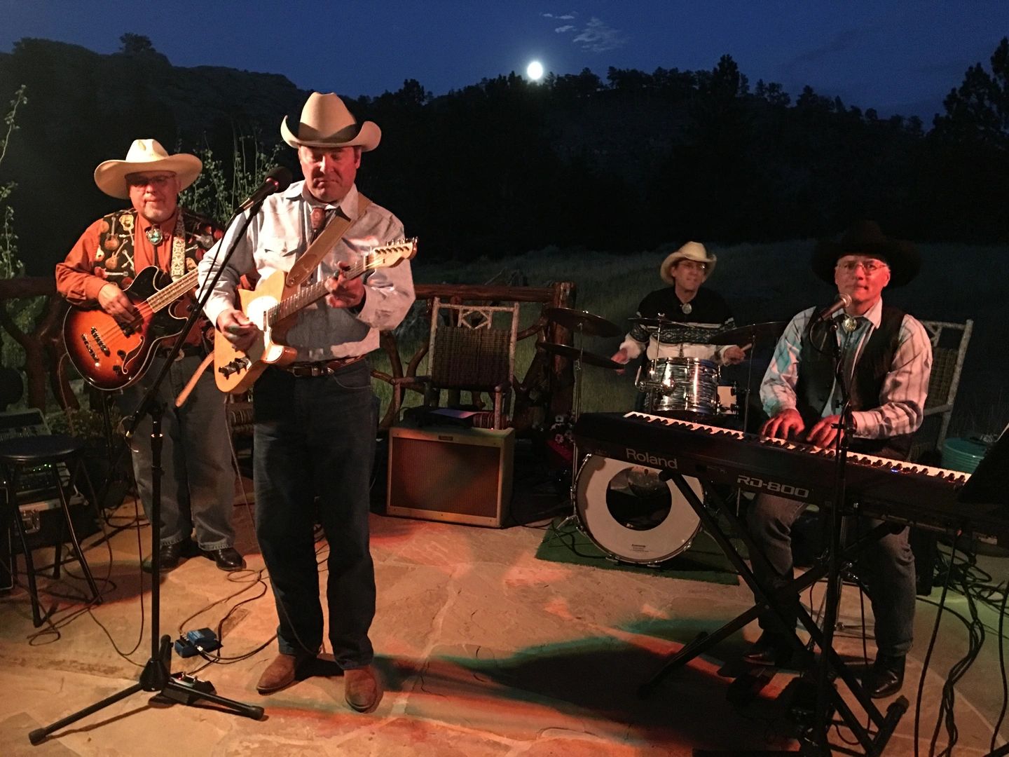 The Elderly Brothers performing outdoors at night